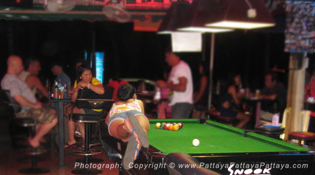 Girl lying on a Pool Table of a beach bar in Pattaya - Photograph Courtesy of Bunker in Pattaya.